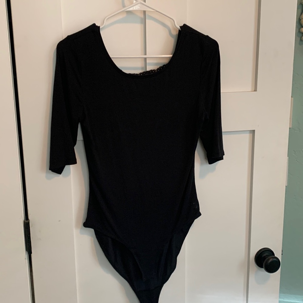Cuddl Duds small black body suit with scoop neck and lace panel on the back.